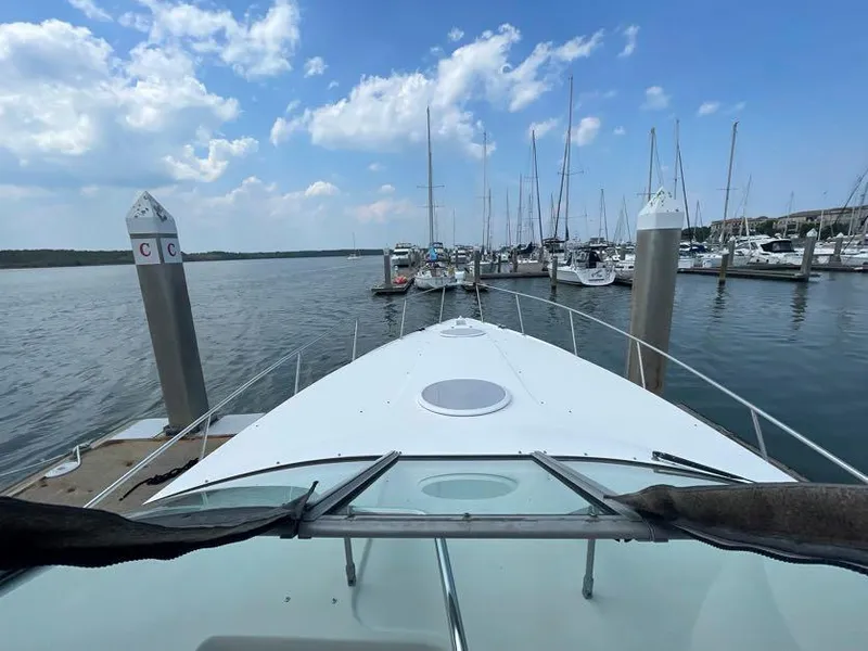 Slide: The Image of 1998 Cruisers Yachts 3375 Esprit docked at marina under blue sky. - 8