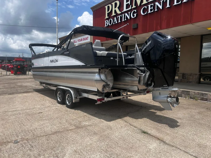Slide: The Image of 2025 Avalon CAT VRB25T pontoon boat on trailer at boating center. - 10