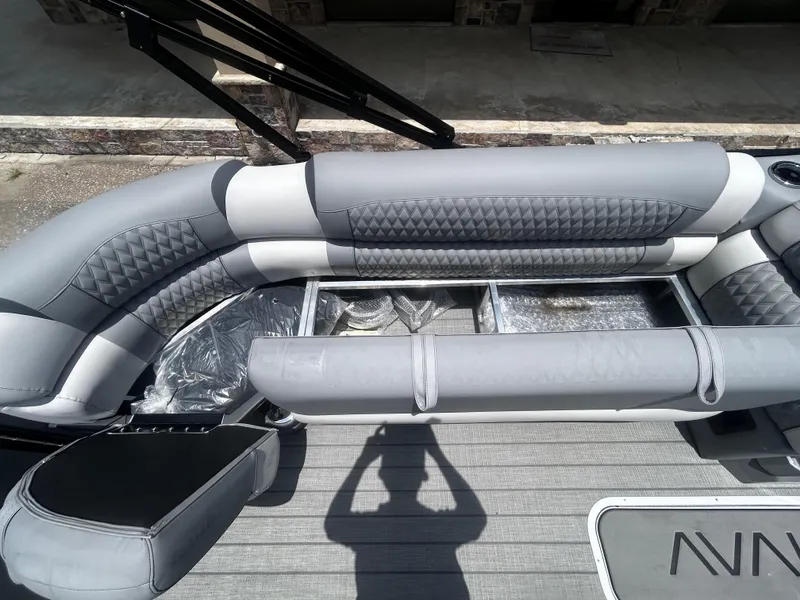 Slide: The Image of Luxurious seating on 2025 Avalon CAT VRB25T boat with storage compartments open. - 13