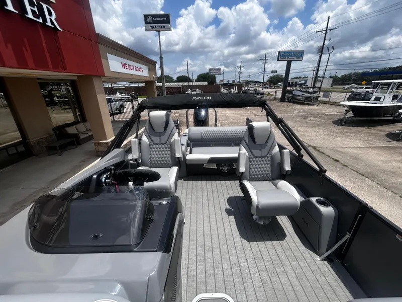 Slide: The Image of Avalon CAT VRB25T 2025 boat interior with modern seating and steering, displayed outdoors. - 18