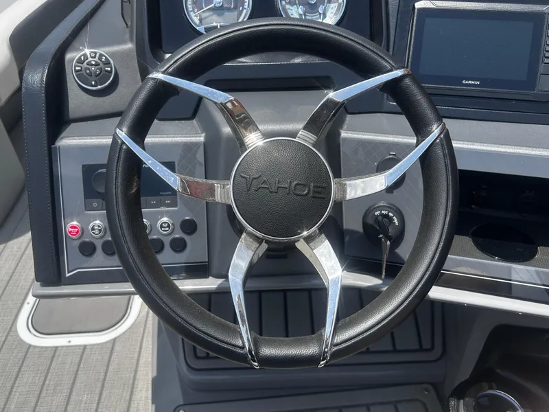 Slide: The Image of Steering wheel of a 2025 Avalon CAT VRB25T boat, featuring modern dashboard controls. - 27