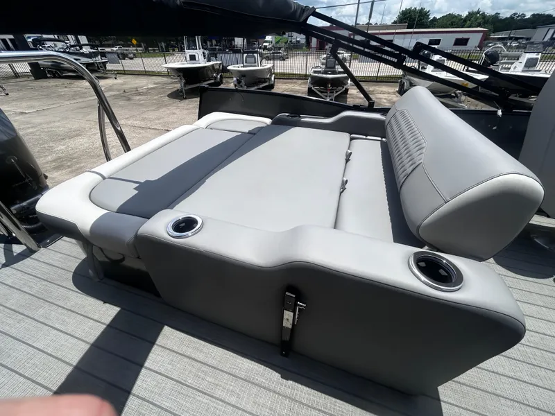 Slide: The Image of Luxurious seating on 2025 Avalon CAT VRB25T boat with cup holders, docked outdoors. - 30