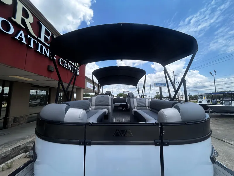 Slide: The Image of 2025 Avalon CAT VRB25T pontoon boat with canopy at dealership under blue sky. - 34