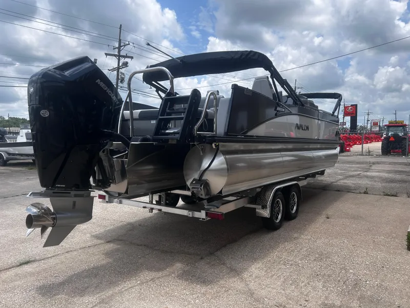 Slide: The Image of 2025 Avalon CAT VRB25T pontoon boat on trailer, featuring a powerful Mercury outboard motor. - 8
