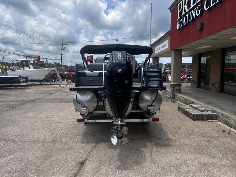 Slide: The Image of 2025 Avalon CAT VRB25T boat at dealership, rear view with outboard motor. - 9