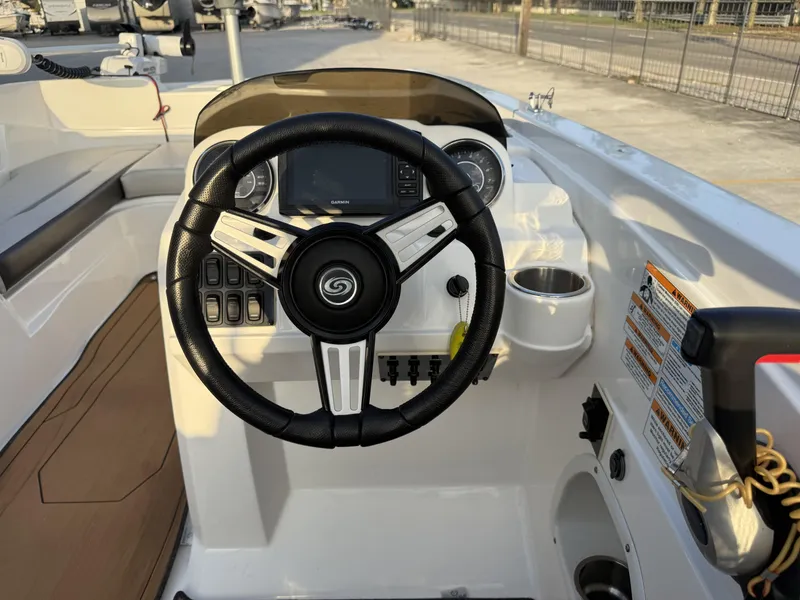 Slide: The Image of Steering wheel of 2022 Hurricane SS205 boat with control panel and cup holder. - 11