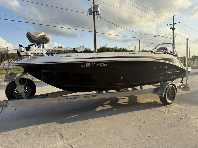 Slide: The Image of 2022 Hurricane SS205 boat on trailer, parked outdoors under a cloudy sky. - 3