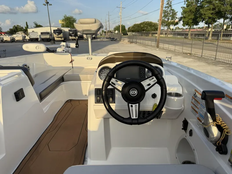 Slide: The Image of 2022 Hurricane SS205 boat cockpit with steering wheel and control panel. - 7