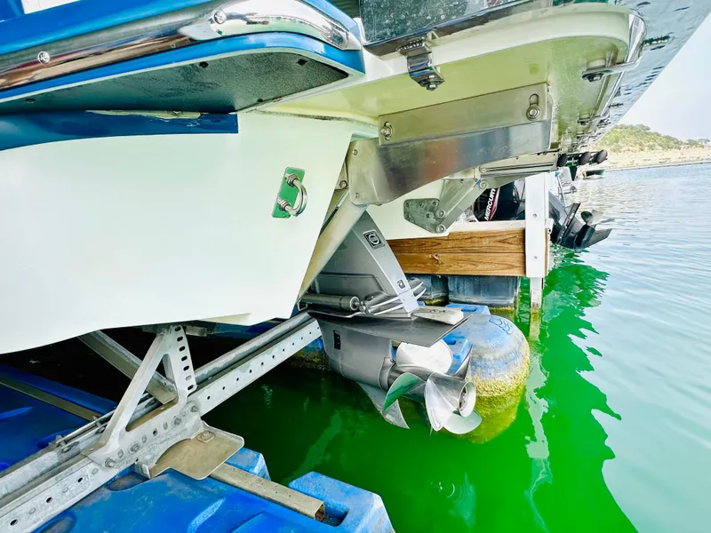 Slide: The Image of 2012 Cobalt A28 boat stern and propeller in green water. - 23