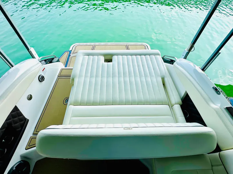 Slide: The Image of 2012 Cobalt A28 boat with luxurious white seating and turquoise water backdrop. - 26