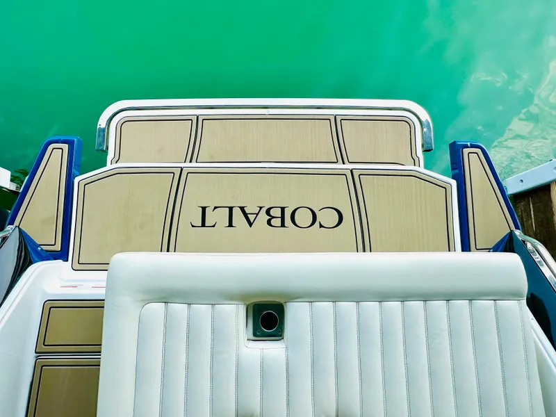 Slide: The Image of 2012 Cobalt A28 boat deck with logo, overlooking turquoise water. - 27