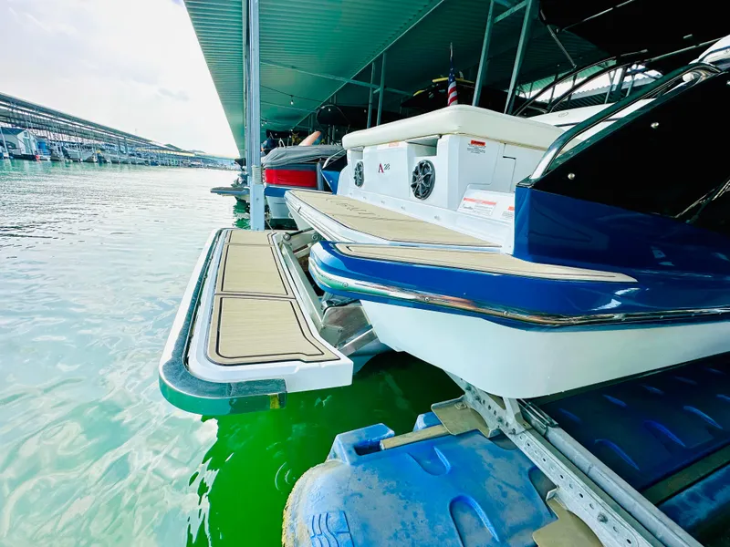 Slide: The Image of 2012 Cobalt A28 boat docked in marina, featuring sleek design and vibrant blue accents. - 29