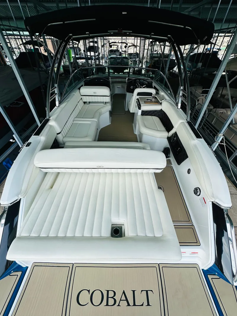 Slide: The Image of 2012 Cobalt A28 boat interior with white seating and sleek design. - 31