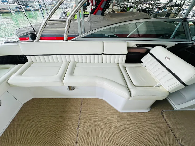 Slide: The Image of 2012 Cobalt A28 boat interior with white leather seating and sleek design. - 35