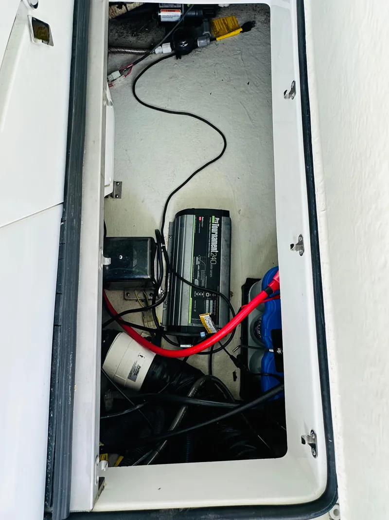 Slide: The Image of 2012 Cobalt A28 boat battery compartment with wiring and charger. - 37