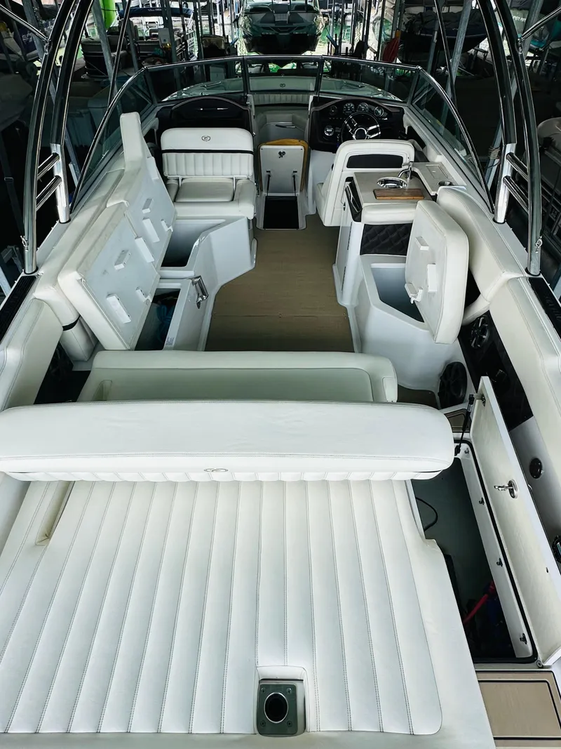 Slide: The Image of 2012 Cobalt A28 boat interior with white seating and modern dashboard. - 38