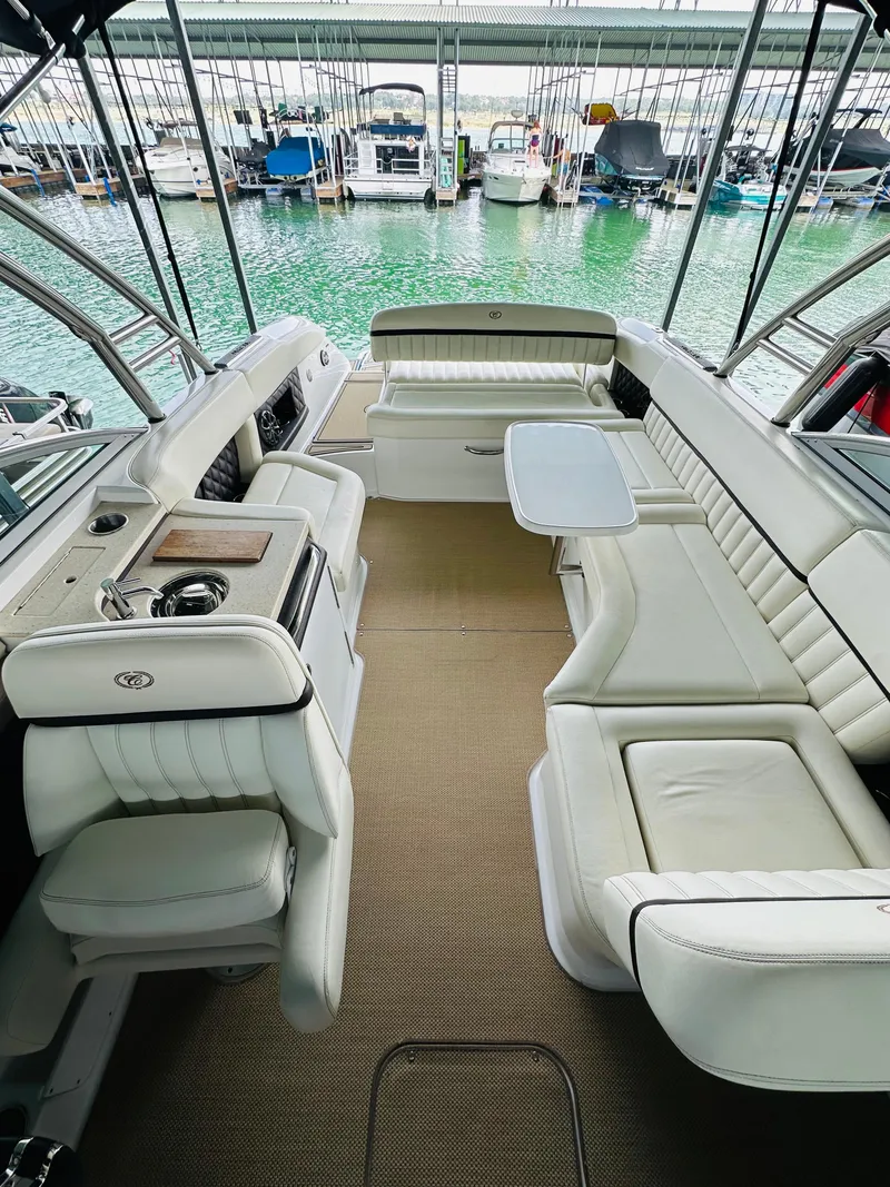 Slide: The Image of Luxurious 2012 Cobalt A28 boat interior with white seating and a small table. - 39