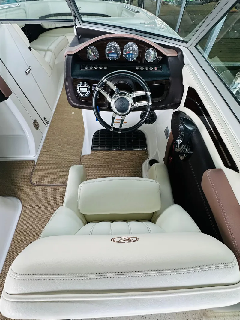 Slide: The Image of Interior of a 2012 Cobalt A28 boat featuring a sleek dashboard and comfortable seating. - 40