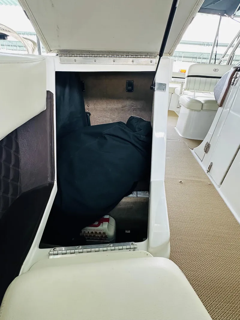 Slide: The Image of 2012 Cobalt A28 boat interior storage compartment with open hatch and visible equipment. - 47