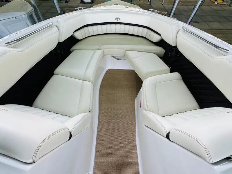 Slide: The Image of 2012 Cobalt A28 boat interior with white leather seating and beige carpet. - 48