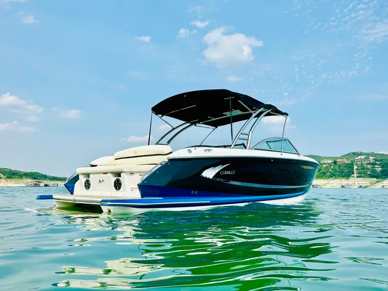 Slide: The Image of 2012 Cobalt A28 boat on calm water under a clear blue sky. - 6