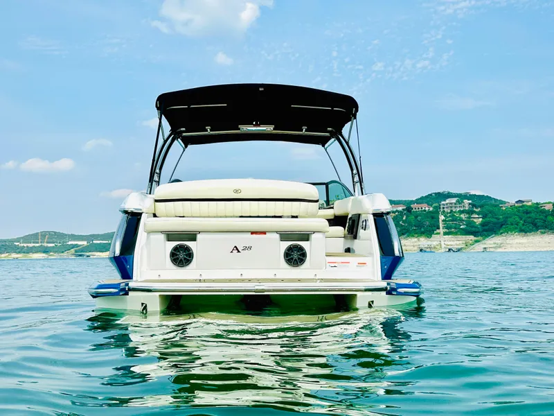 Slide: The Image of 2012 Cobalt A28 boat on a serene lake with scenic hills in the background. - 7