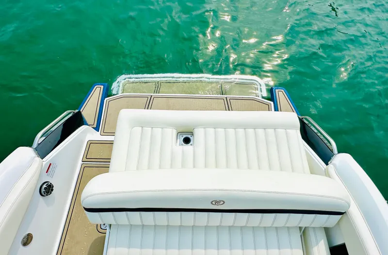 Slide: The Image of 2012 Cobalt A28 boat with white seating and swim platform on clear water. - 8