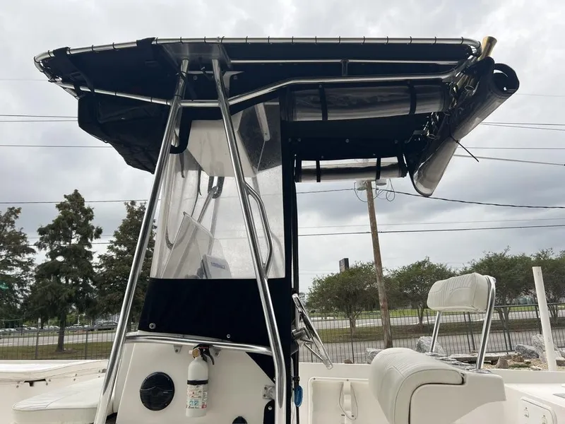 Slide: The Image of 2005 ProKat Bay Kat boat with T-top and seating, overcast sky background. - 13
