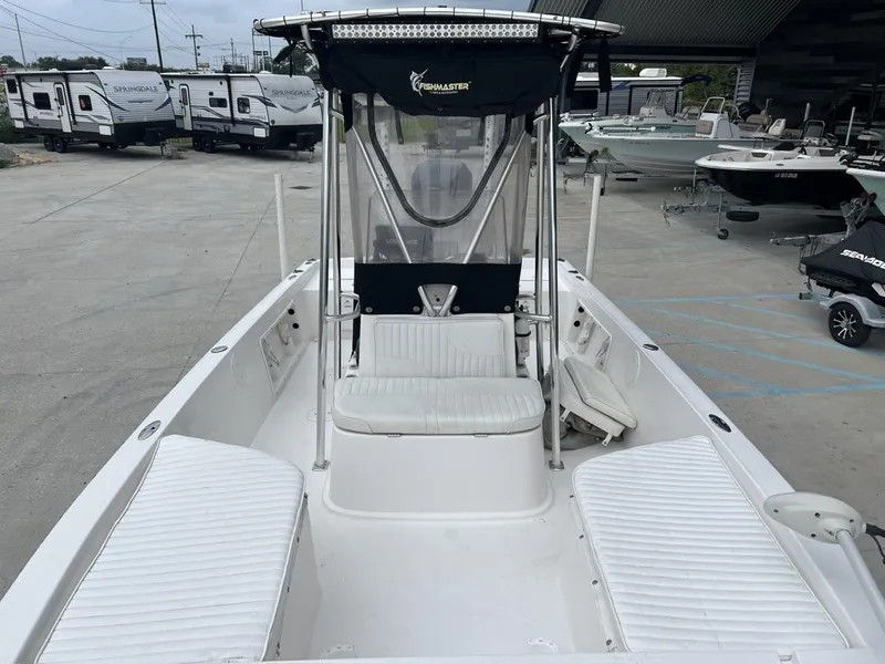 Slide: The Image of 2005 ProKat Bay Kat boat with seating, parked near RVs and other boats. - 15