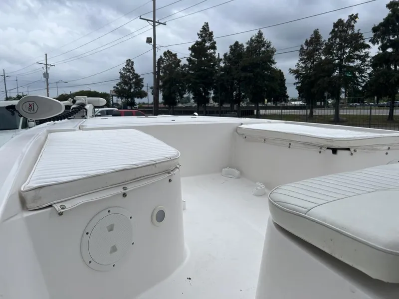 Slide: The Image of 2005 ProKat Bay Kat boat interior with cushioned seating and overcast sky. - 16