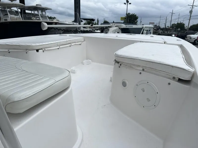 Slide: The Image of 2005 ProKat Bay Kat boat interior with white cushioned seating and overcast sky. - 17