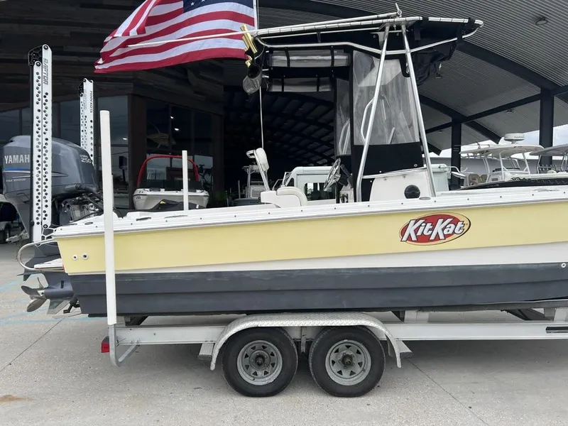 Slide: The Image of 2005 ProKat Bay Kat boat on trailer with American flag, labeled "Kit Kat." - 2