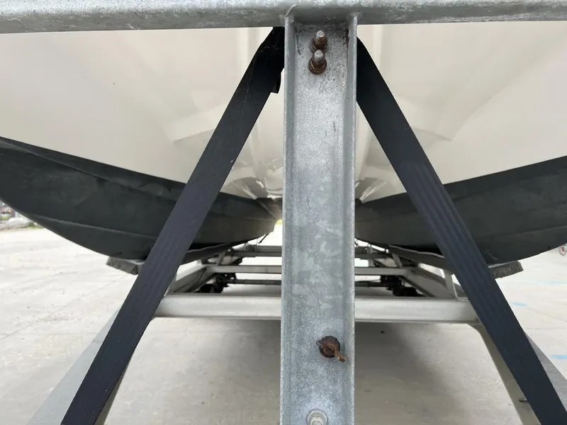 Slide: The Image of 2005 ProKat Bay Kat boat secured on trailer with straps. - 5