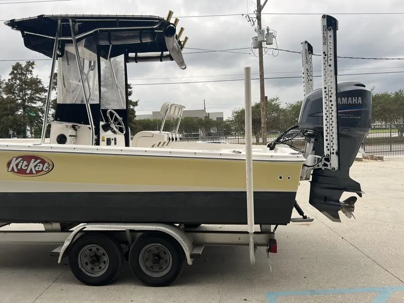 Slide: The Image of 2005 ProKat Bay Kat boat on trailer with Yamaha outboard motor, parked outdoors. - 7