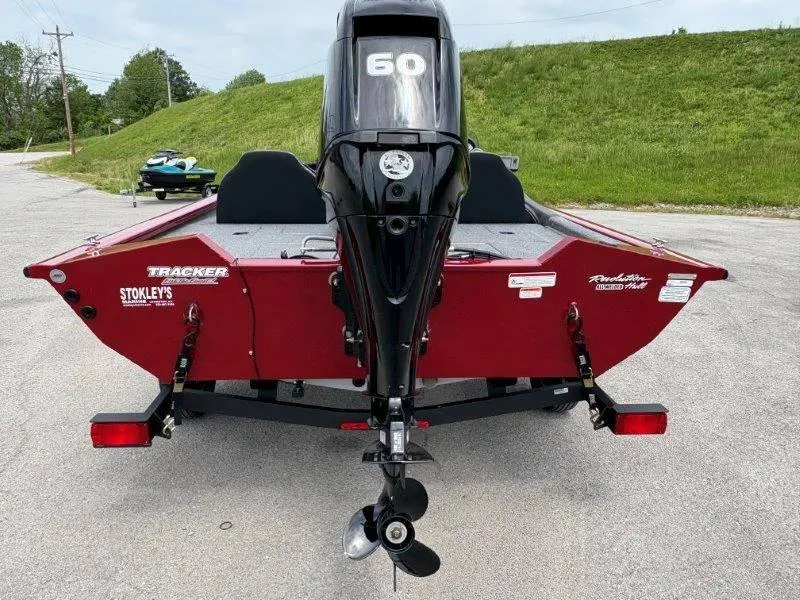 Slide: The Image of 2019 Tracker Pro Team 175 boat with 60 HP motor, red exterior, parked on trailer. - 12