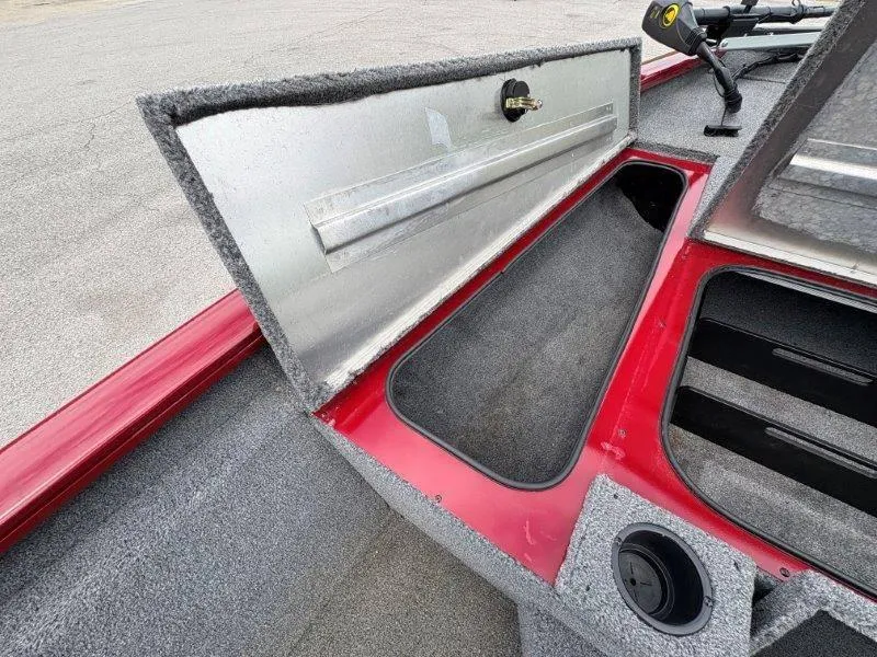 Slide: The Image of 2019 Tracker Pro Team 175 boat storage compartment with open lid, showcasing interior space. - 35