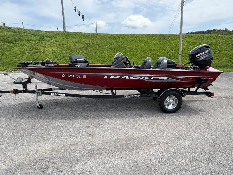 Slide: The Image of 2019 Tracker Pro Team 175 boat on trailer, red color, parked outdoors. - 4