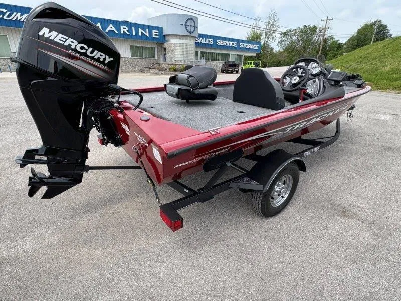 Slide: The Image of 2019 Tracker Pro Team 175 boat with Mercury engine, parked outside a marine dealership. - 6