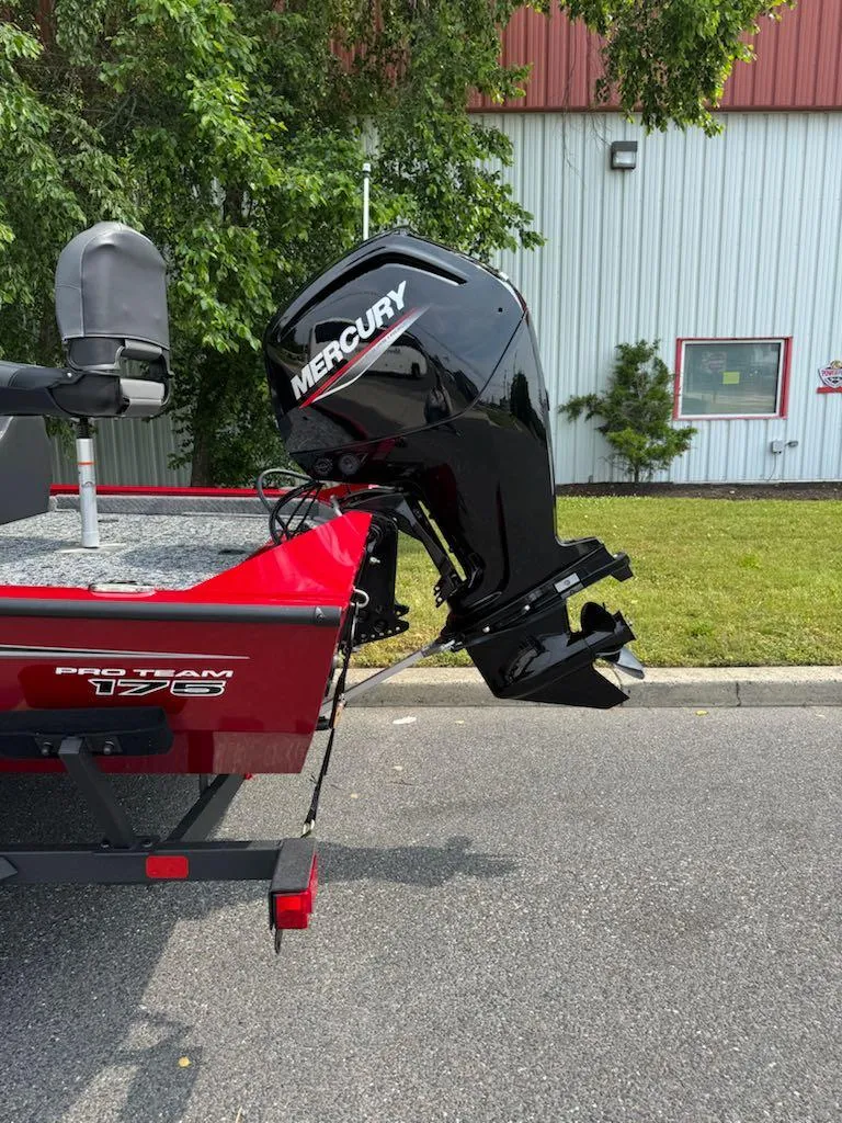 Slide: The Image of 2025 Tracker Pro Team 175 boat with Mercury outboard motor, parked outdoors. - 3