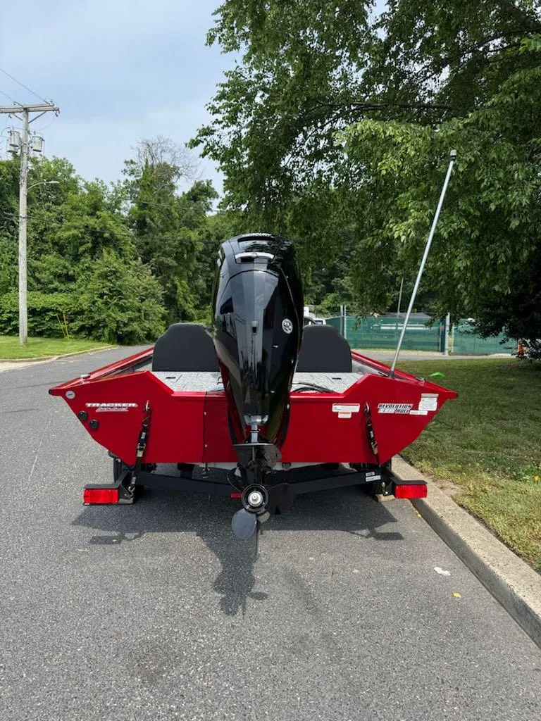 Slide: The Image of 2025 Tracker Pro Team 175 boat on a trailer, parked on a road. - 4