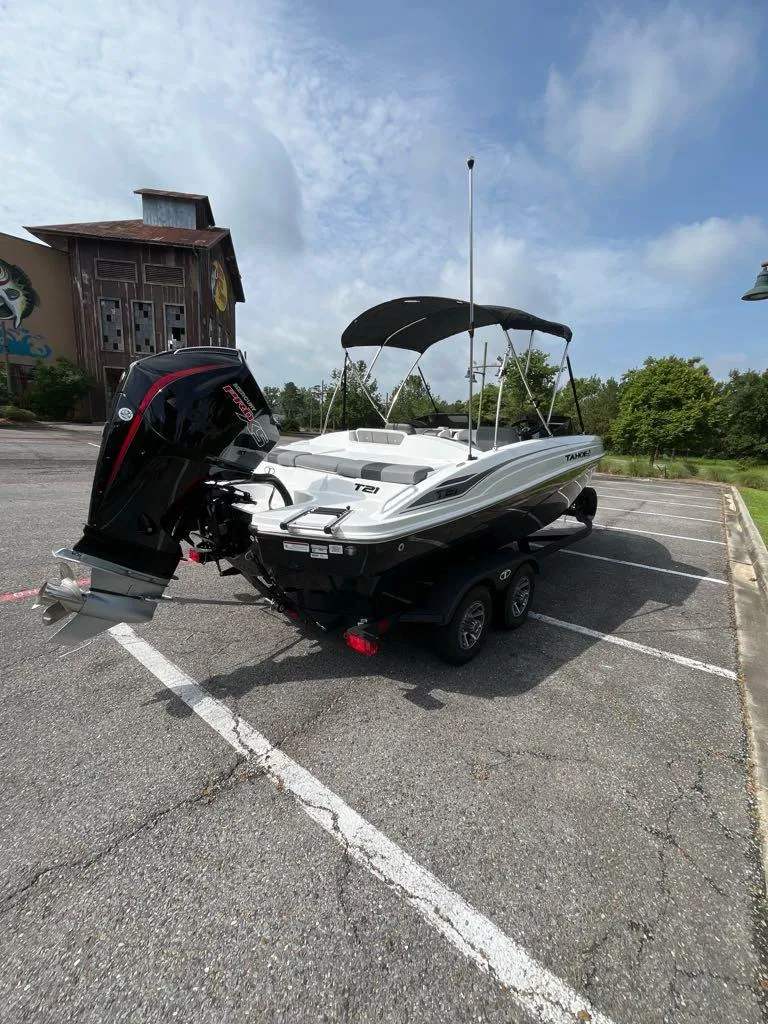 Slide: The Image of 2025 Tahoe T21 boat on trailer in parking lot, sunny day. - 4