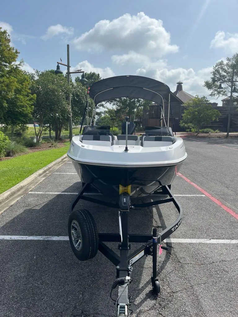 Slide: The Image of 2025 Tahoe T21 boat on trailer in parking lot, sunny day. - 6