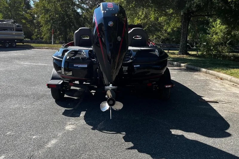 Slide: The Image of 2025 Nitro Z19 boat with powerful outboard motor in a sunny parking lot. - 4