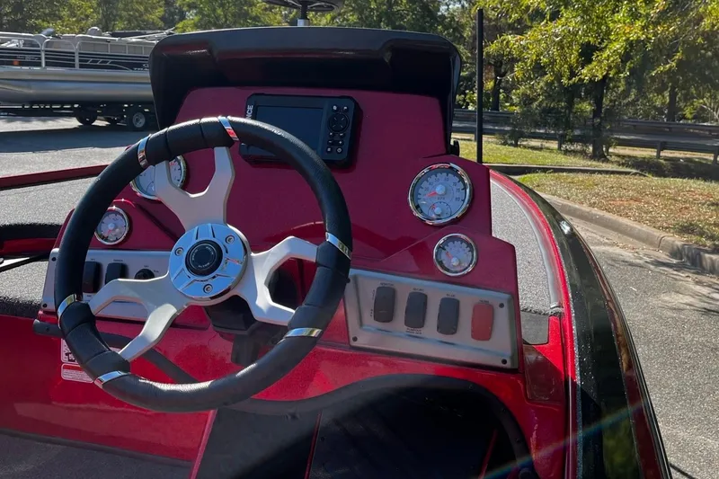 Slide: The Image of ```json
"2025 Nitro Z19 boat dashboard with steering wheel and gauges in sunlight."
``` - 6