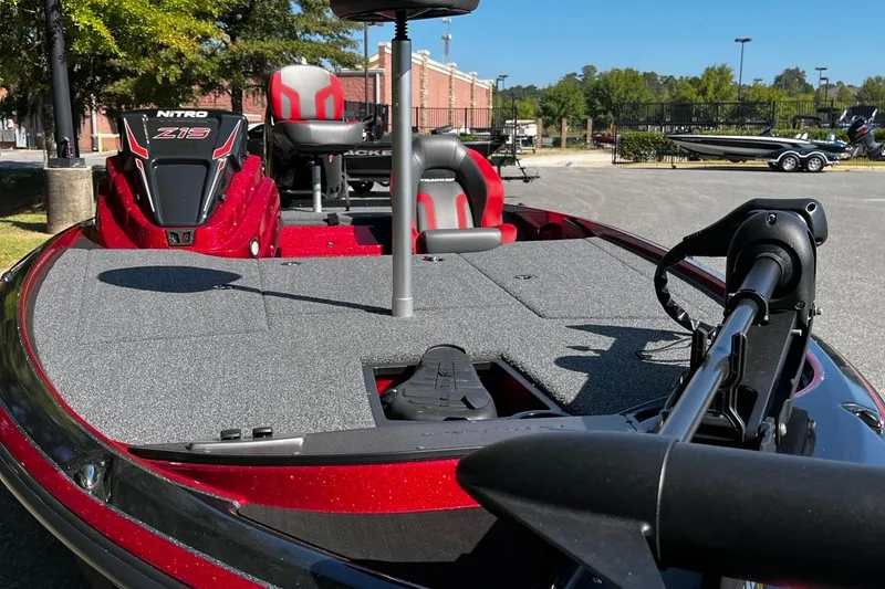 Slide: The Image of 2025 Nitro Z19 boat with red accents, featuring a spacious deck and modern seating. - 7