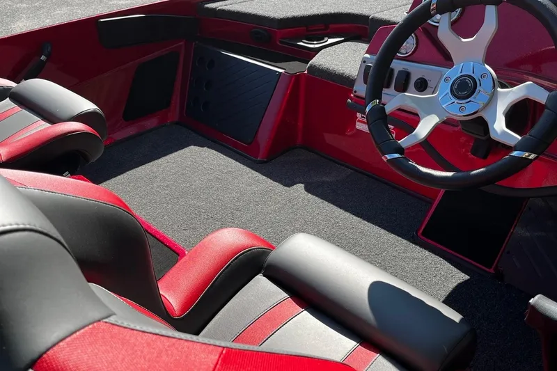 Slide: The Image of 2025 Nitro Z19 boat interior with red and black seats, steering wheel, and dashboard. - 8
