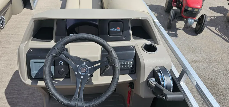 Slide: The Image of 2025 Sun Tracker Party Barge 20 DLX dashboard with steering wheel and controls. - 10