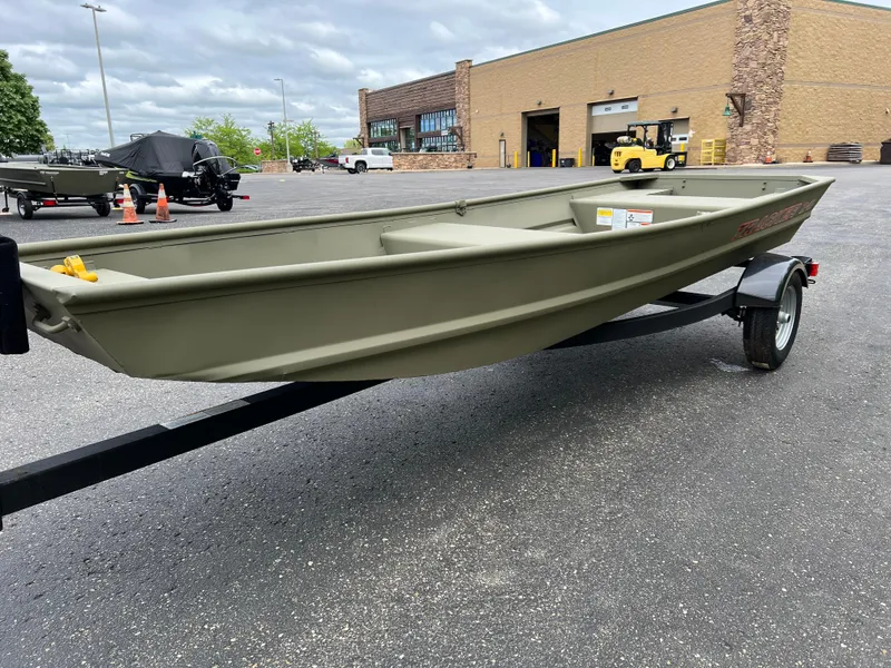 Slide: The Image of 2025 Tracker Grizzly 14 Jon boat on trailer in parking lot. - 2