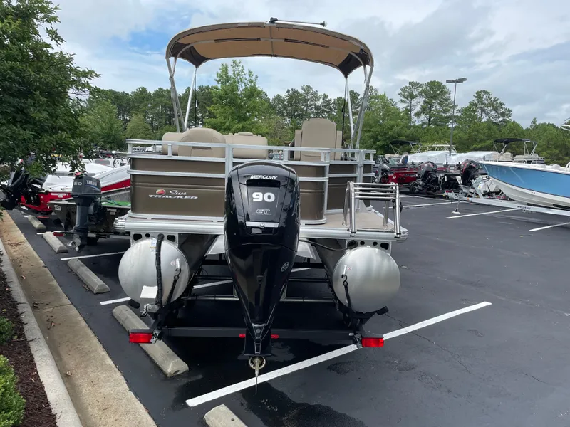 Slide: The Image of 2025 Sun Tracker SportFish 20 DLX pontoon boat with Mercury 90 engine in parking lot. - 3