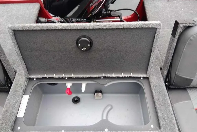 Slide: The Image of 2025 Tracker Targa V-18 Combo boat storage compartment with open lid. - 79